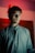 a man standing in a room with a red light