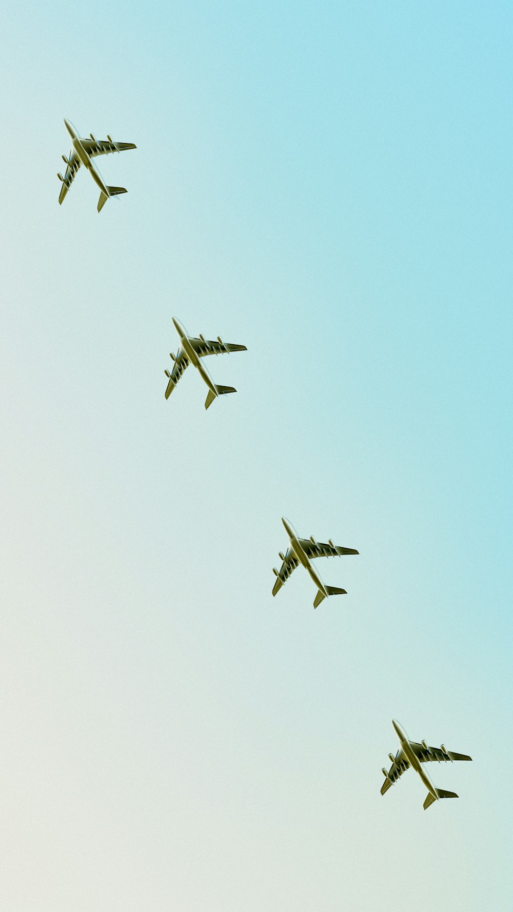 four airplanes flying in formation in the sky