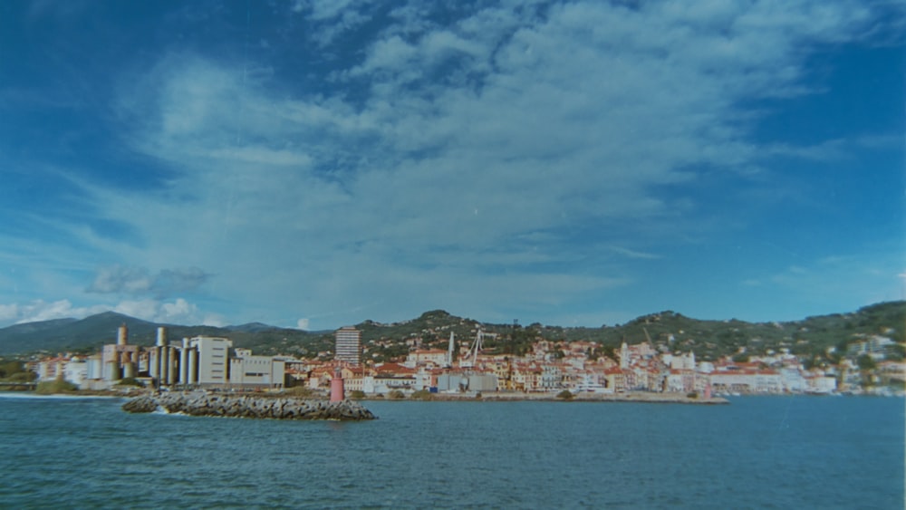 a body of water with a city in the background