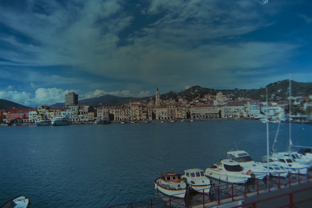 a group of boats sitting in a harbor next to a city