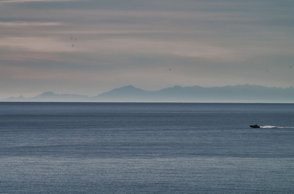 a lone boat in the middle of a large body of water