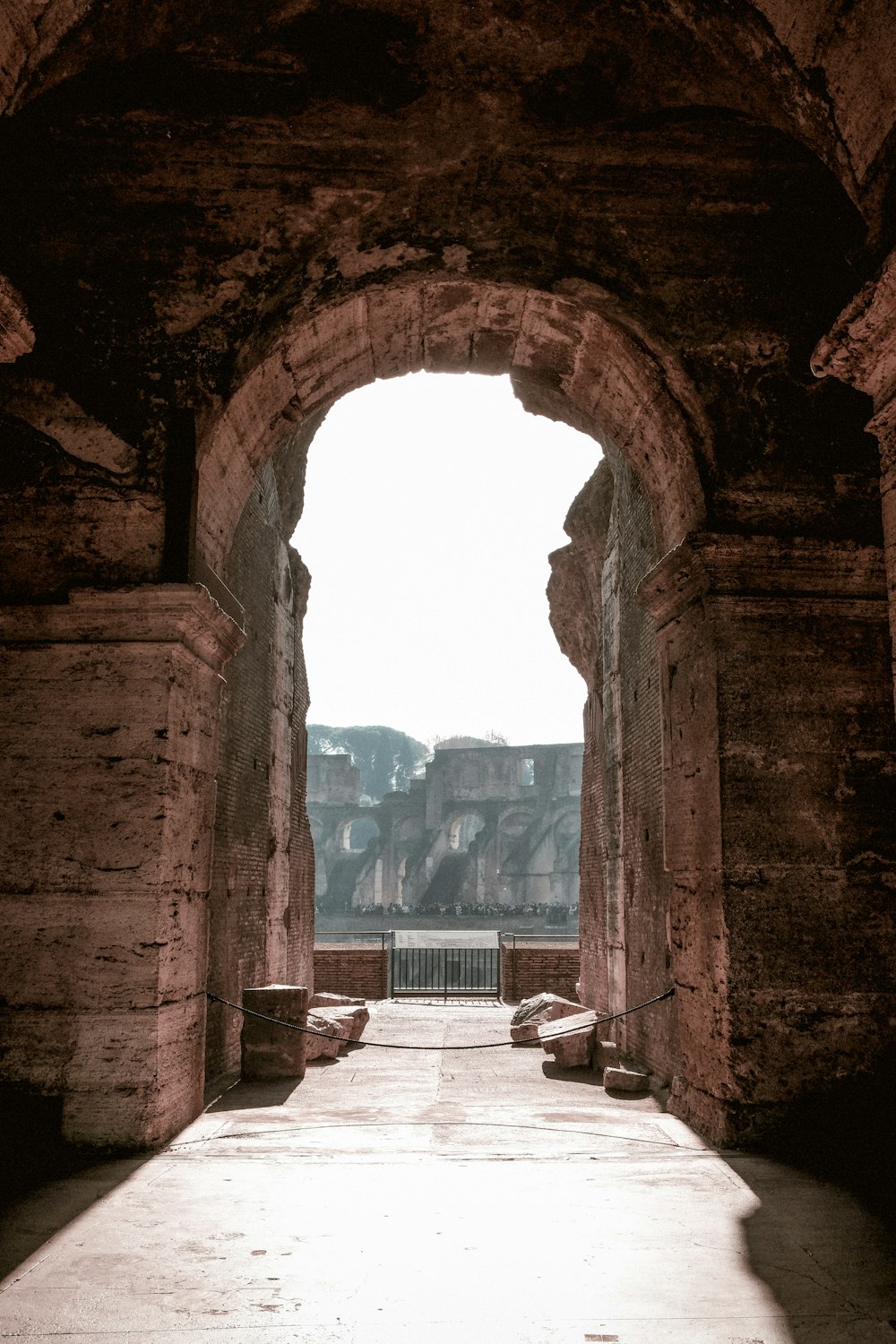 a stone archway with benches in the middle of it