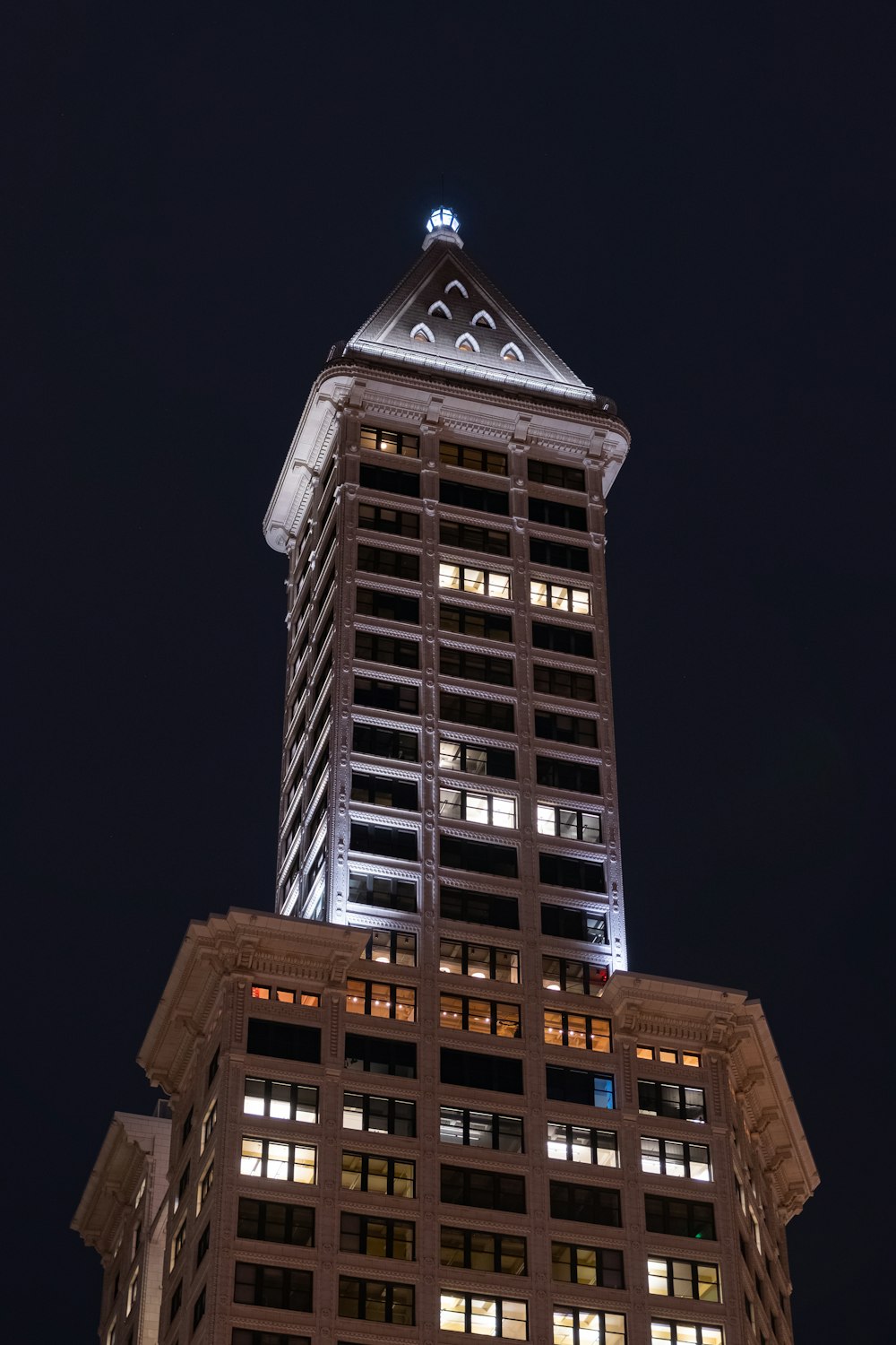 a tall building lit up at night time