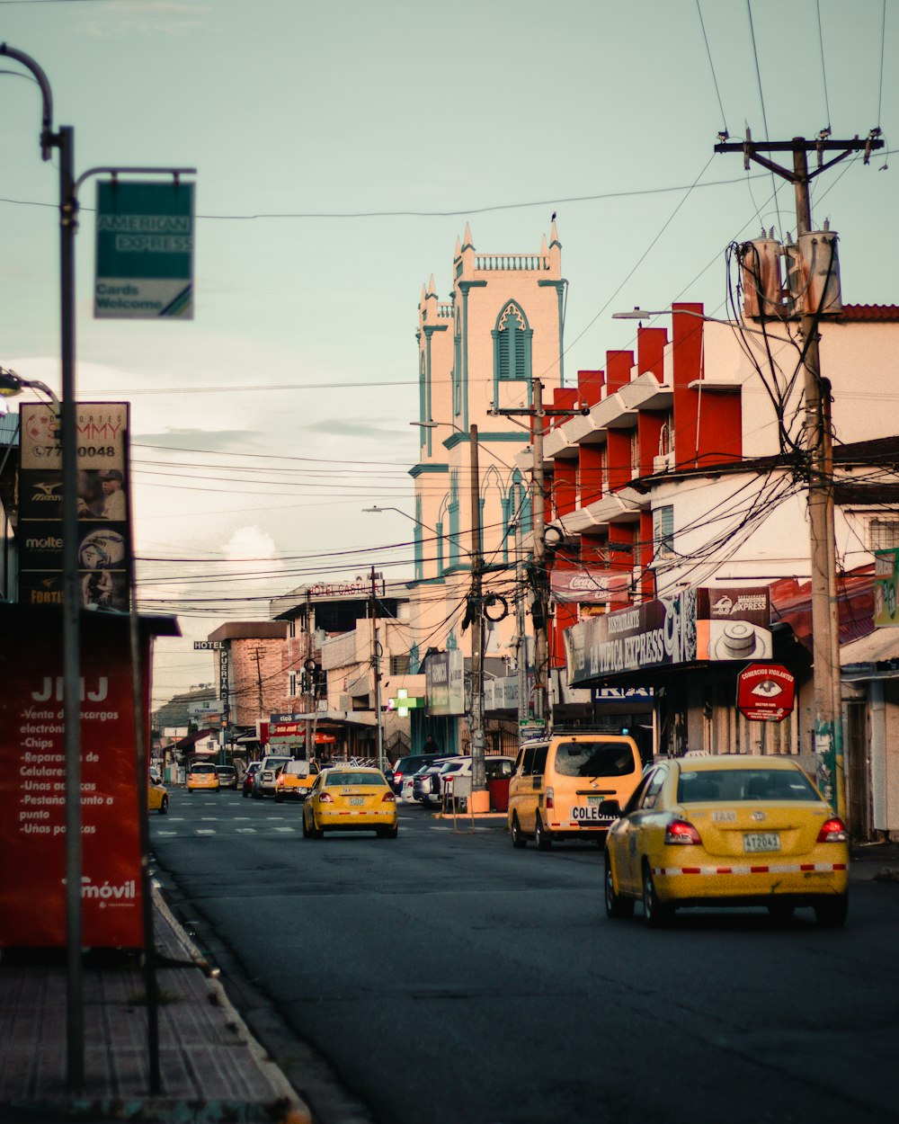 a street filled with lots of traffic next to tall buildings