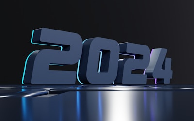 Bold 3D numbers displaying '2024' with a modern, futuristic design. The numbers appear on a glossy, reflective surface against a dark background. Subtle lighting accents create a sleek and sophisticated look.