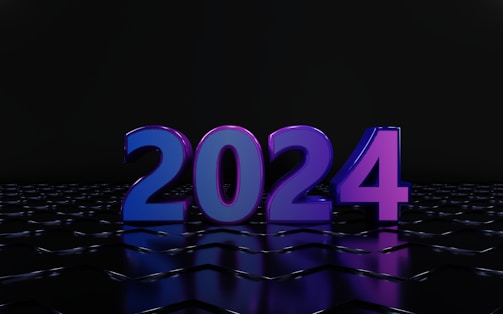 A large, glossy 3D rendering of the number 2024 stands prominently against a dark background. The numbers are illuminated in vibrant shades of blue and purple, reflecting off a sleek, tiled surface.