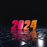 Brightly colored numerals displaying the year 2024 stand boldly on a reflective, futuristic black surface. The numbers are illuminated with gradients of pink and orange, creating a vibrant and modern appearance. The background is a deep black, adding contrast and emphasizing the glossy texture of the surface.