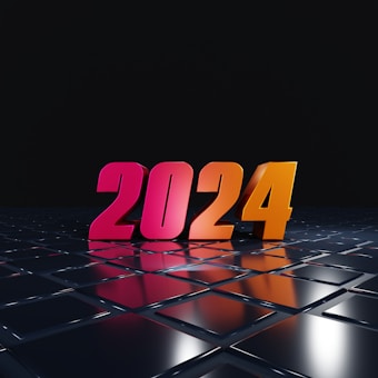 Brightly colored numerals displaying the year 2024 stand boldly on a reflective, futuristic black surface. The numbers are illuminated with gradients of pink and orange, creating a vibrant and modern appearance. The background is a deep black, adding contrast and emphasizing the glossy texture of the surface.