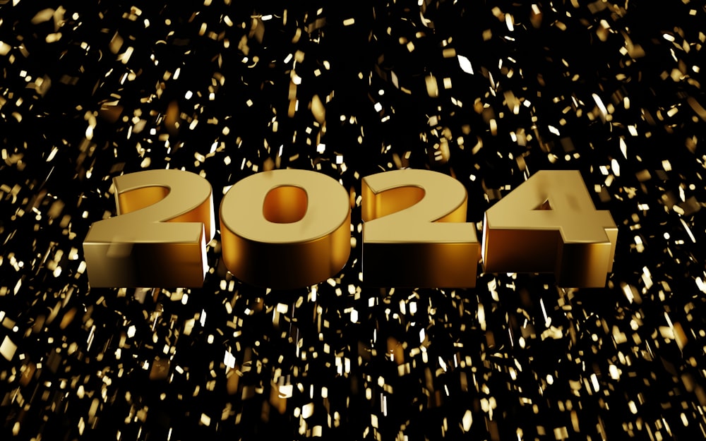 a golden new year sign with a lot of confetti around it