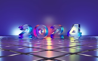 Large 3D numbers '2024' stand on a reflective tiled surface, illuminated by colorful lighting that casts a gradient across the scene. The background features a smooth gradient transitioning from blue to purple, complementing the shiny metallic look of the numbers.