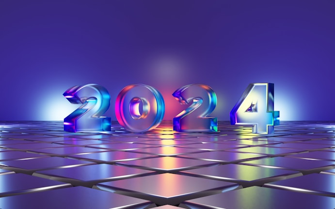 Large 3D numbers '2024' stand on a reflective tiled surface, illuminated by colorful lighting that casts a gradient across the scene. The background features a smooth gradient transitioning from blue to purple, complementing the shiny metallic look of the numbers.