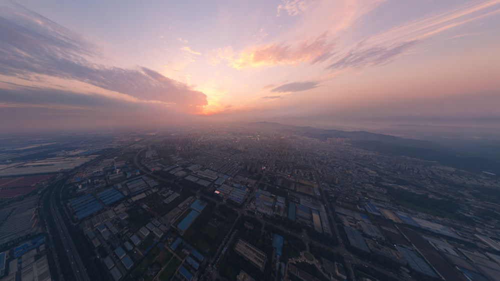 an aerial view of a city at sunset