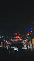 A vibrant party bus interior glowing with colorful LED lights and plush seating.
