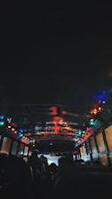 A vibrant party bus lit up at night with people laughing and celebrating inside.