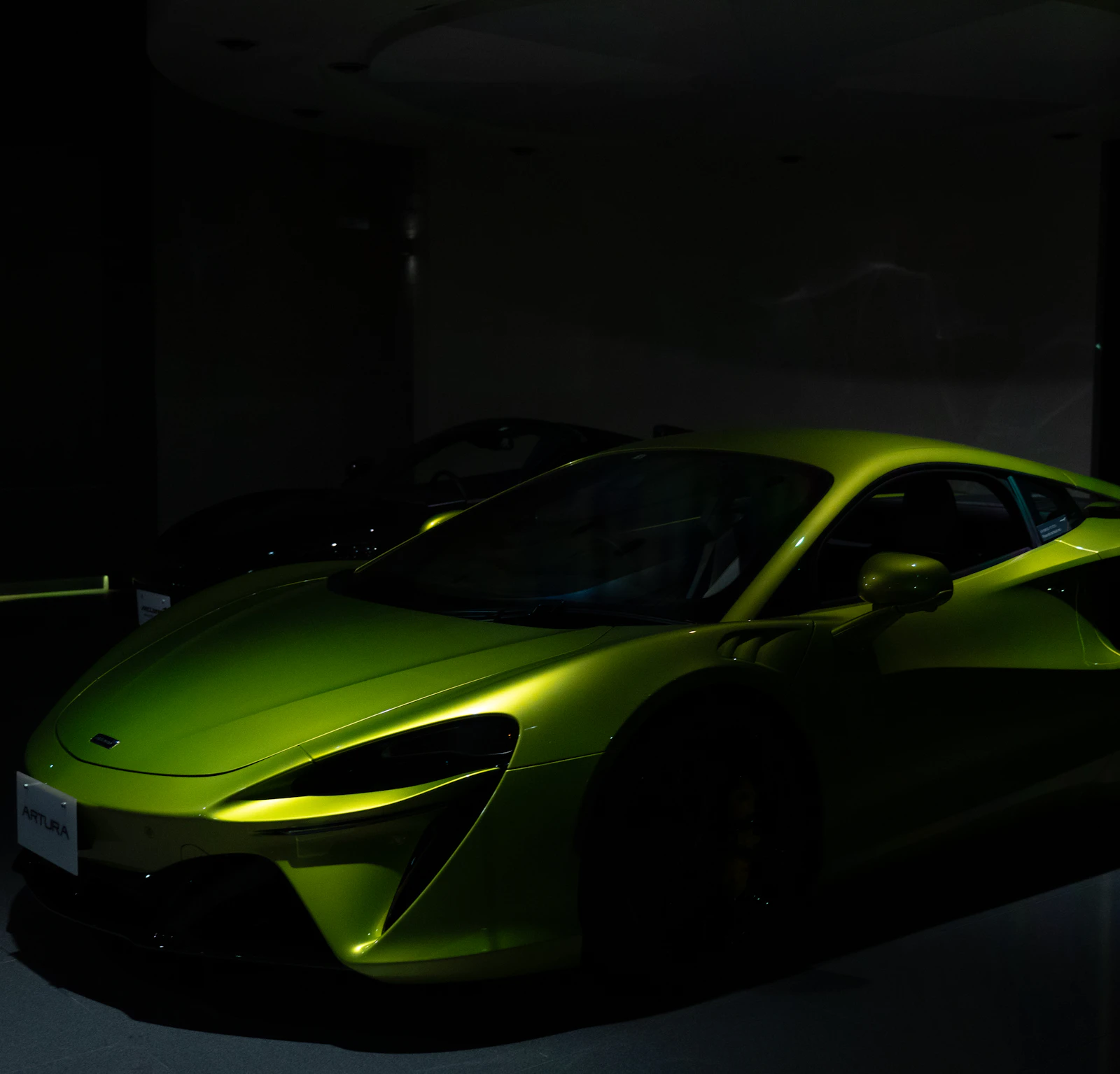 Green McLaren in a dark room