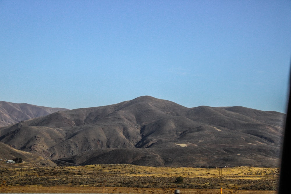 a view of a mountain range from a train window