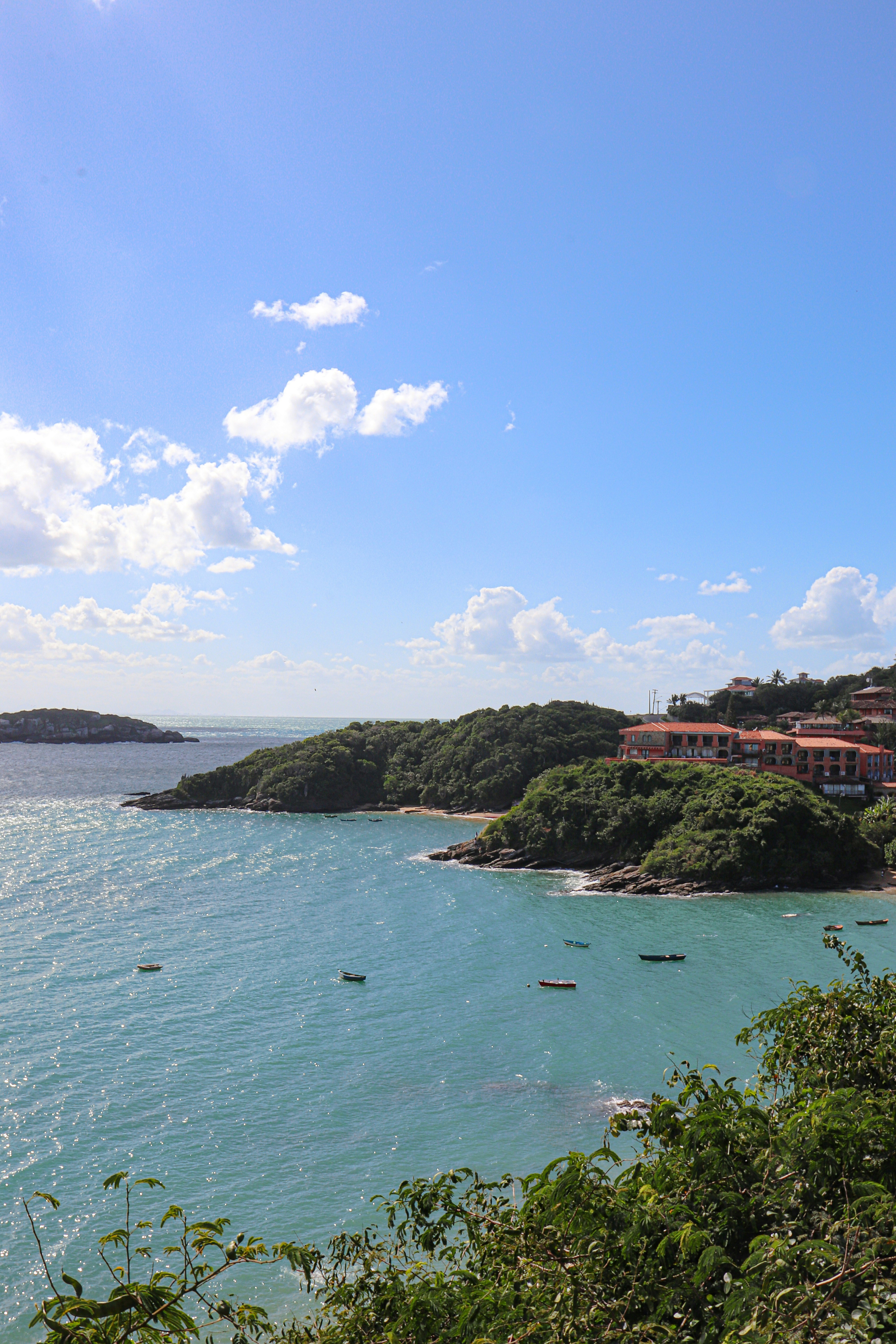 a body of water surrounded by a lush green hillside