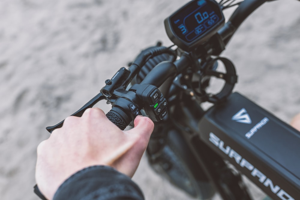 a person holding a camera next to a bike