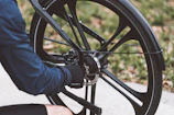 Technician adjusting brakes on a mountain bike with focused attention.