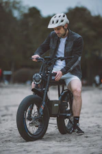A friendly bike rider wearing a helmet waiting for a passenger