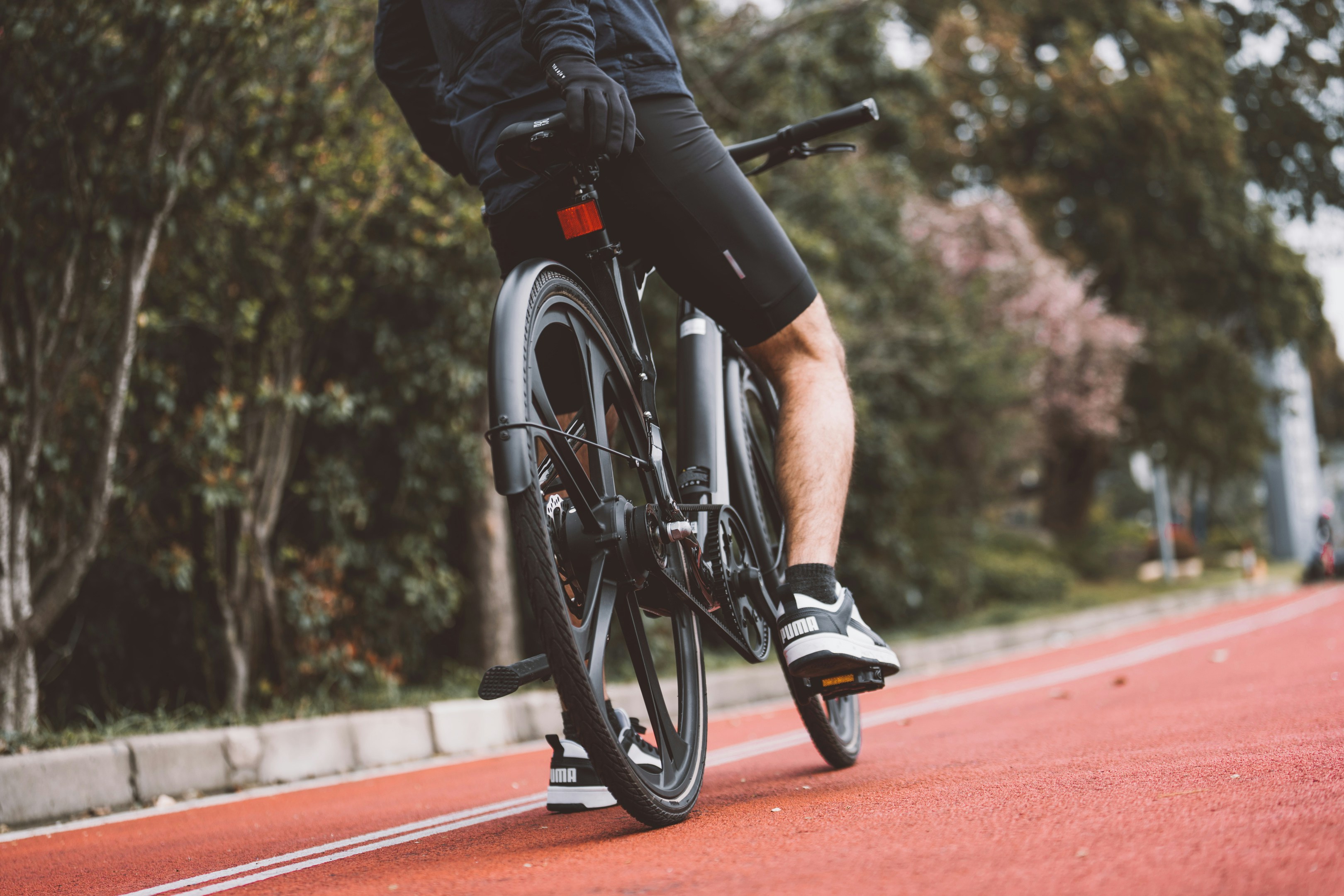 a man riding a bike down a street