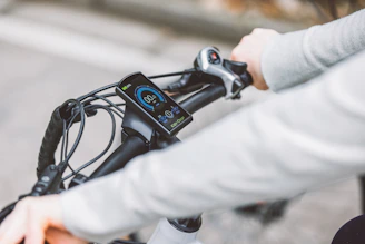 Close-up of a rider's gloved hand gripping the handlebar, ready to accelerate.