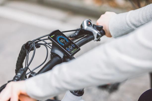 Close-up of a rider's hand gripping the nerva exe ii handlebar, showing the digital display and controls.