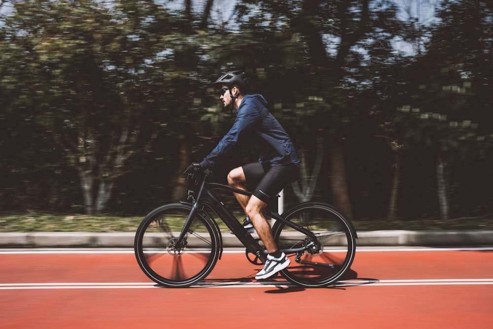 a man riding a bike on a tennis court