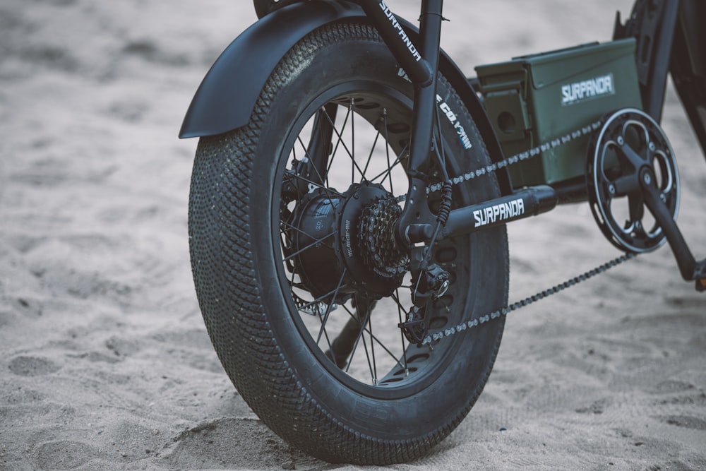 a close up of a motorcycle tire on the sand
