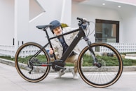 A person happily retrieving their bike from a parking spot.