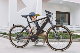A person happily retrieving their bike from a parking spot.