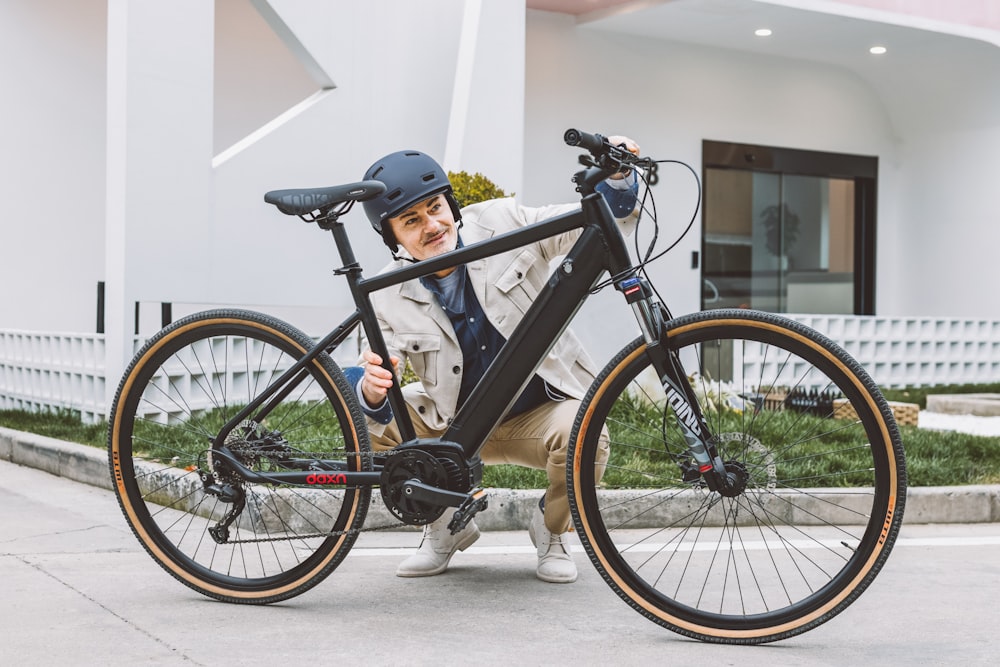 a man sitting on the ground next to a bike