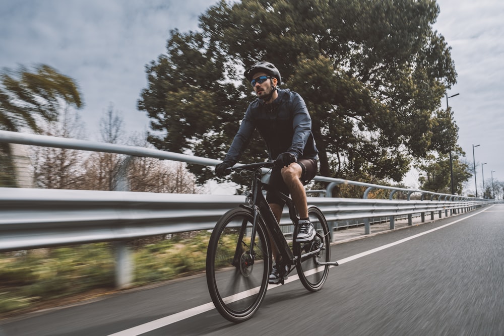 a man riding a bike down a street