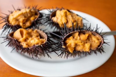 A vibrant display of fresh sea urchins on a wooden table.
