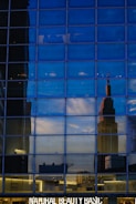 Commercial storefront with glass facade reflecting the city skyline.