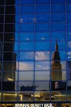 Commercial storefront with glass facade reflecting the city skyline.