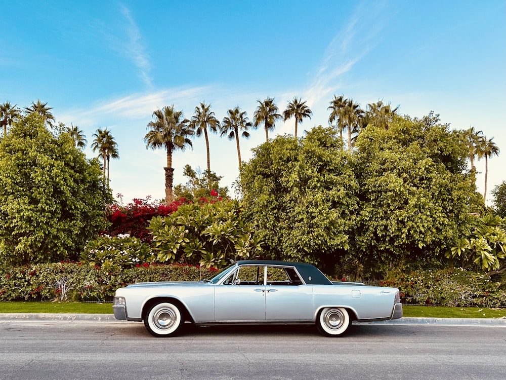 a classic car parked on the side of the road