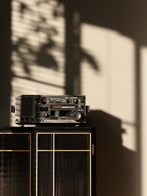 Marantz receiver showcased on a wooden shelf with warm ambient lighting highlighting its brushed metal finish.