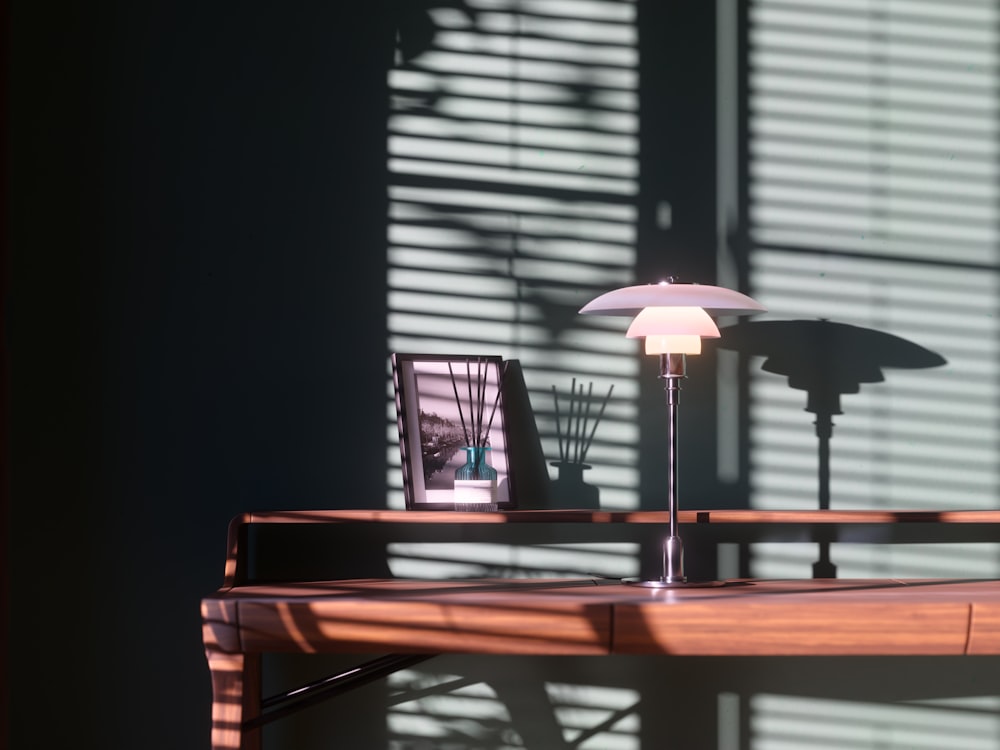 a desk with a lamp and a picture on it
