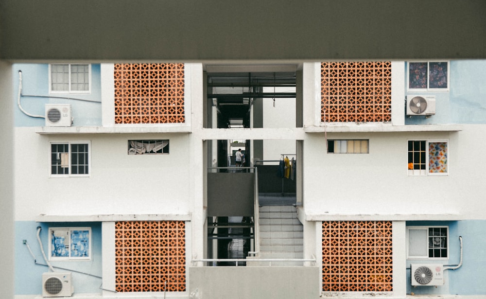 a view of a building through a hole in the wall