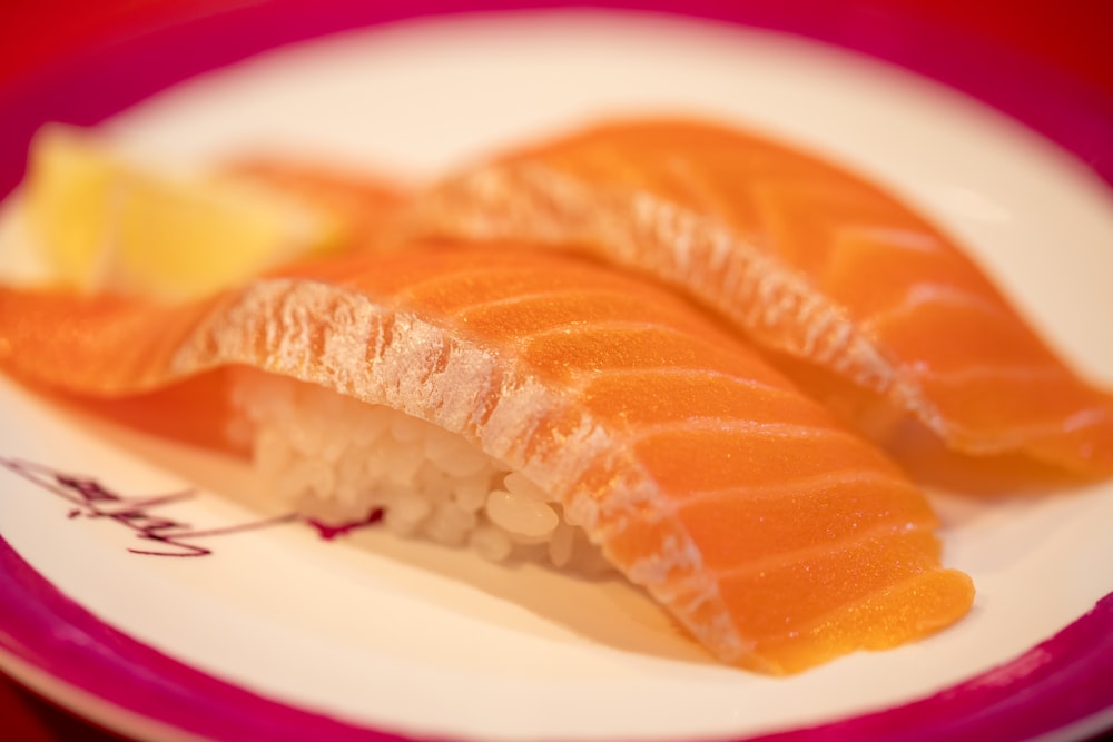 a white plate topped with sushi and a slice of lemon