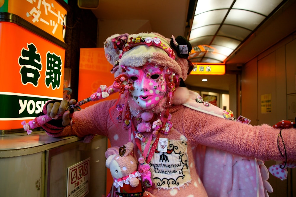 a person in a pink costume and a teddy bear