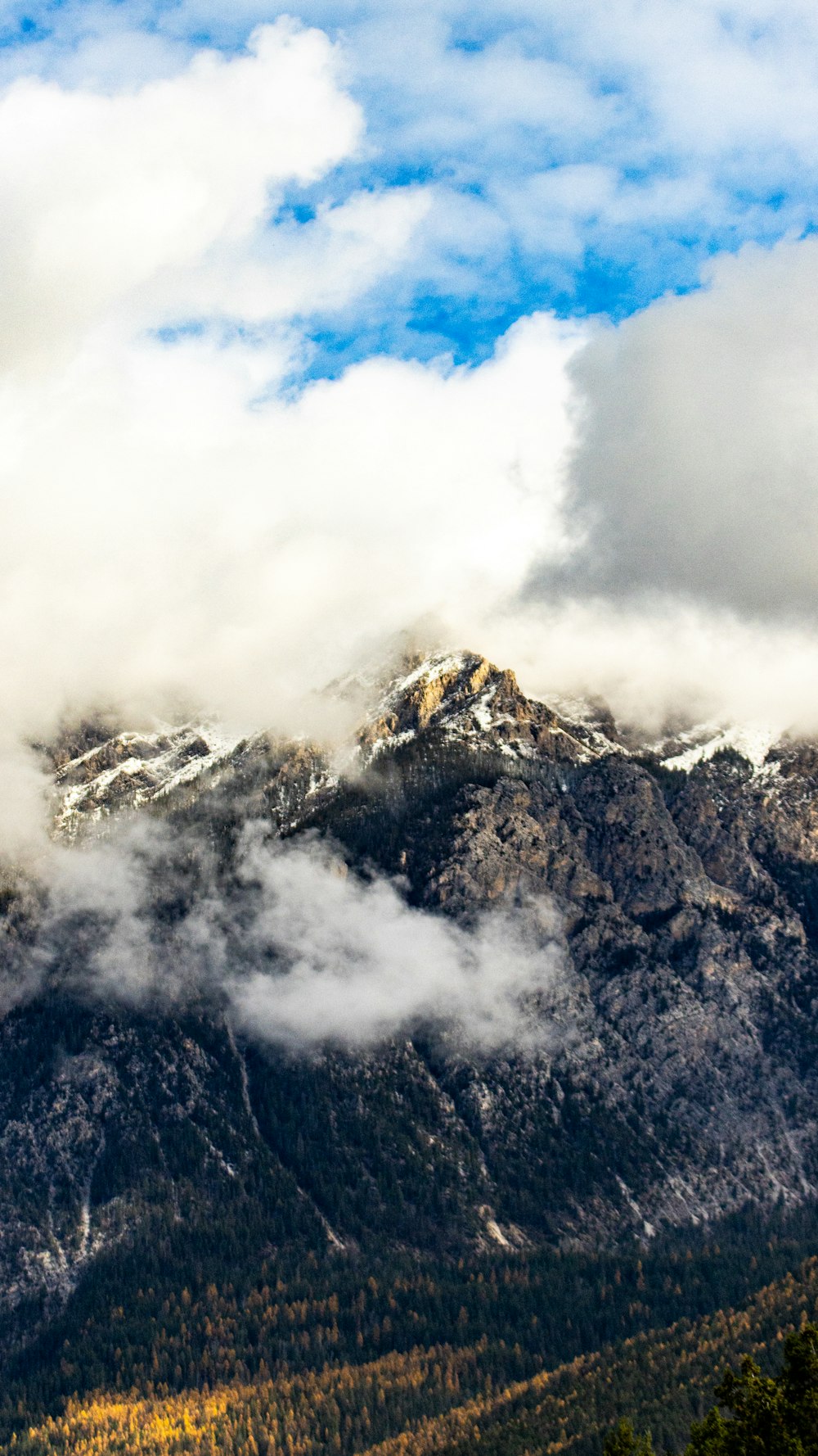 a view of a mountain range with clouds in the sky