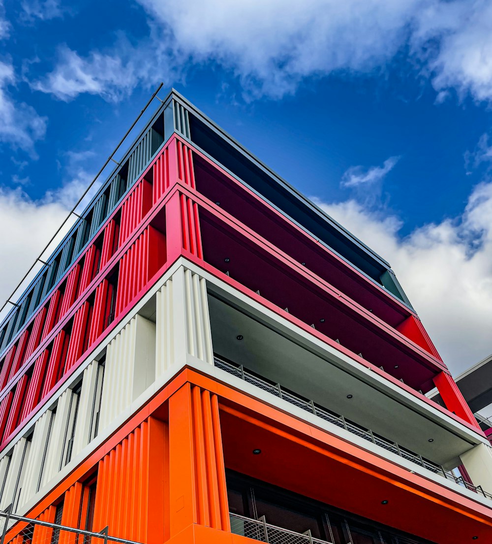 an orange and white building with a blue sky in the background