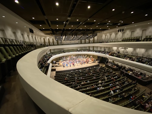 Audience watching a contemporary music concert in an intimate hall.