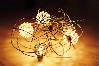 An artful arrangement of glowing spheres suspended in midair, radiating soft pastel lights.