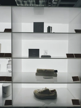 A minimalist display of Lumina sneakers and accessories on a concrete bench.