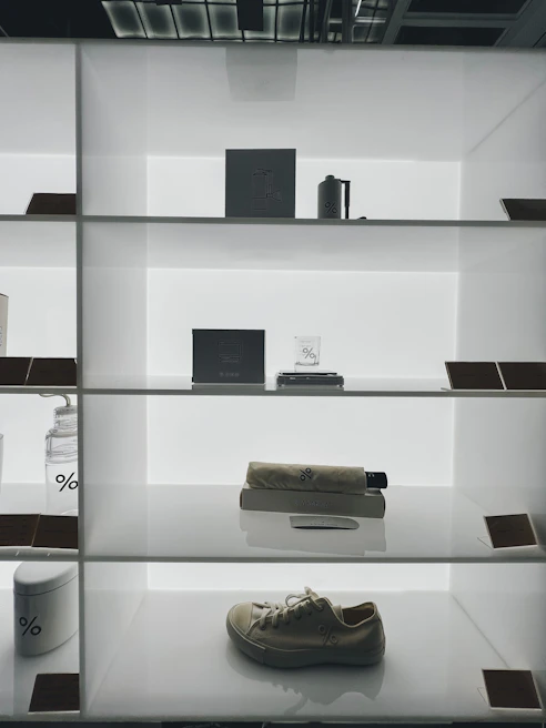 Colorful merchandise items neatly displayed on minimalist shelves, highlighting Improvegallery's collection.