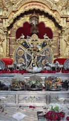 A vibrant red and black themed altar decorated with Ogum symbols and candles.