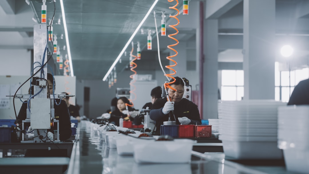 a group of people working in a factory,